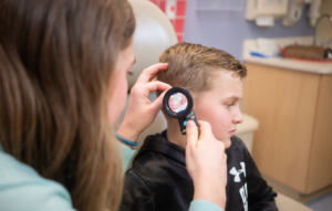 Male pediatric patient getting ear exam with Wispr Digital Otoscope